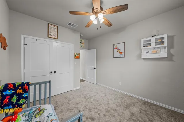 a bedroom with furniture and a ceiling fan