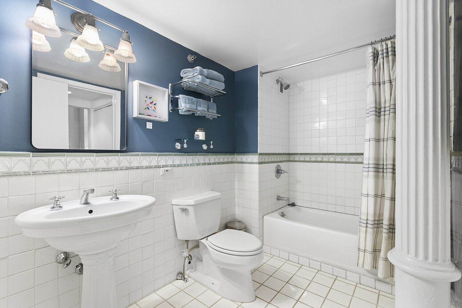 121 West 20th Street, Unit 2D Manhattan, NY 10011 - Photo 10 of 13 a bathroom with a sink toilet and shower