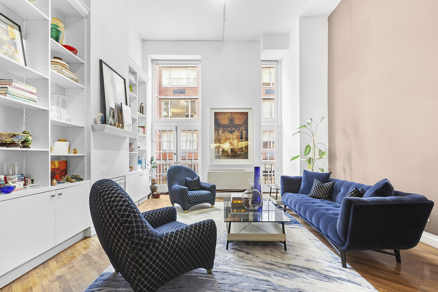 121 West 20th Street, Unit 2D Manhattan, NY 10011 - Photo 1 of 13 a living room with furniture and a window