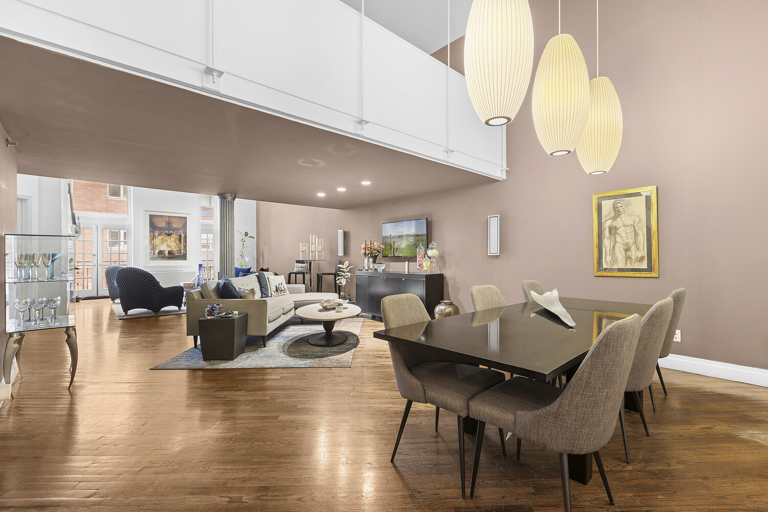 121 West 20th Street, Unit 2D Manhattan, NY 10011 - Photo 4 of 13 a view of a dining room with furniture a chandelier and wooden floor