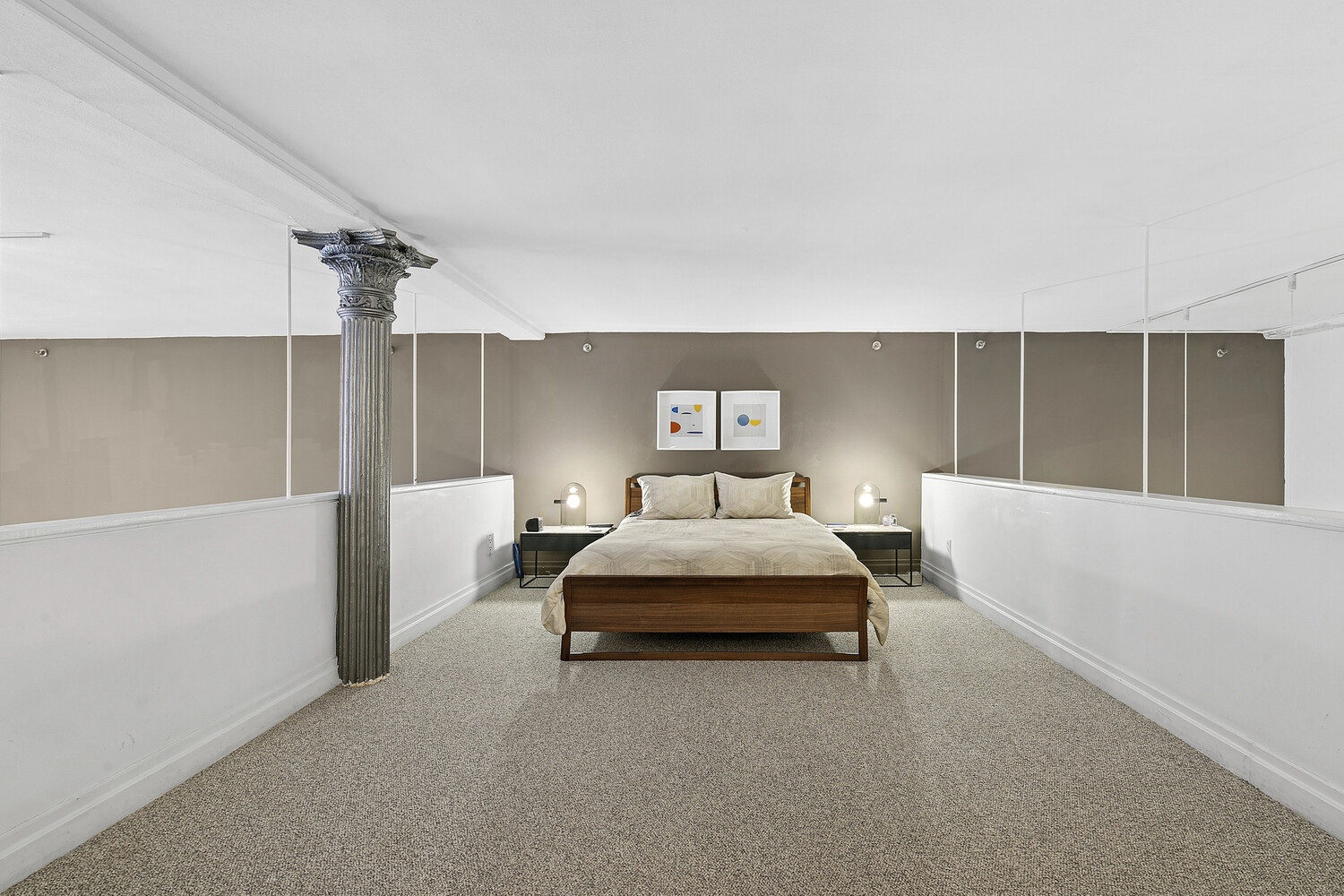 121 West 20th Street, Unit 2D Manhattan, NY 10011 - Photo 6 of 13 a spacious bedroom with a bed and lamp