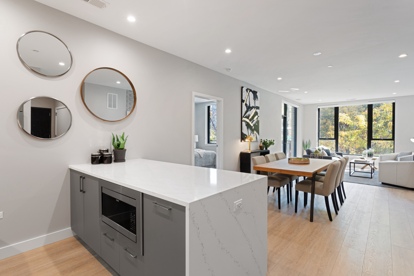 Undisclosed Address Chicago, IL 60618 - Photo 18 of 34 a living room with furniture a clock potted plant and a large window