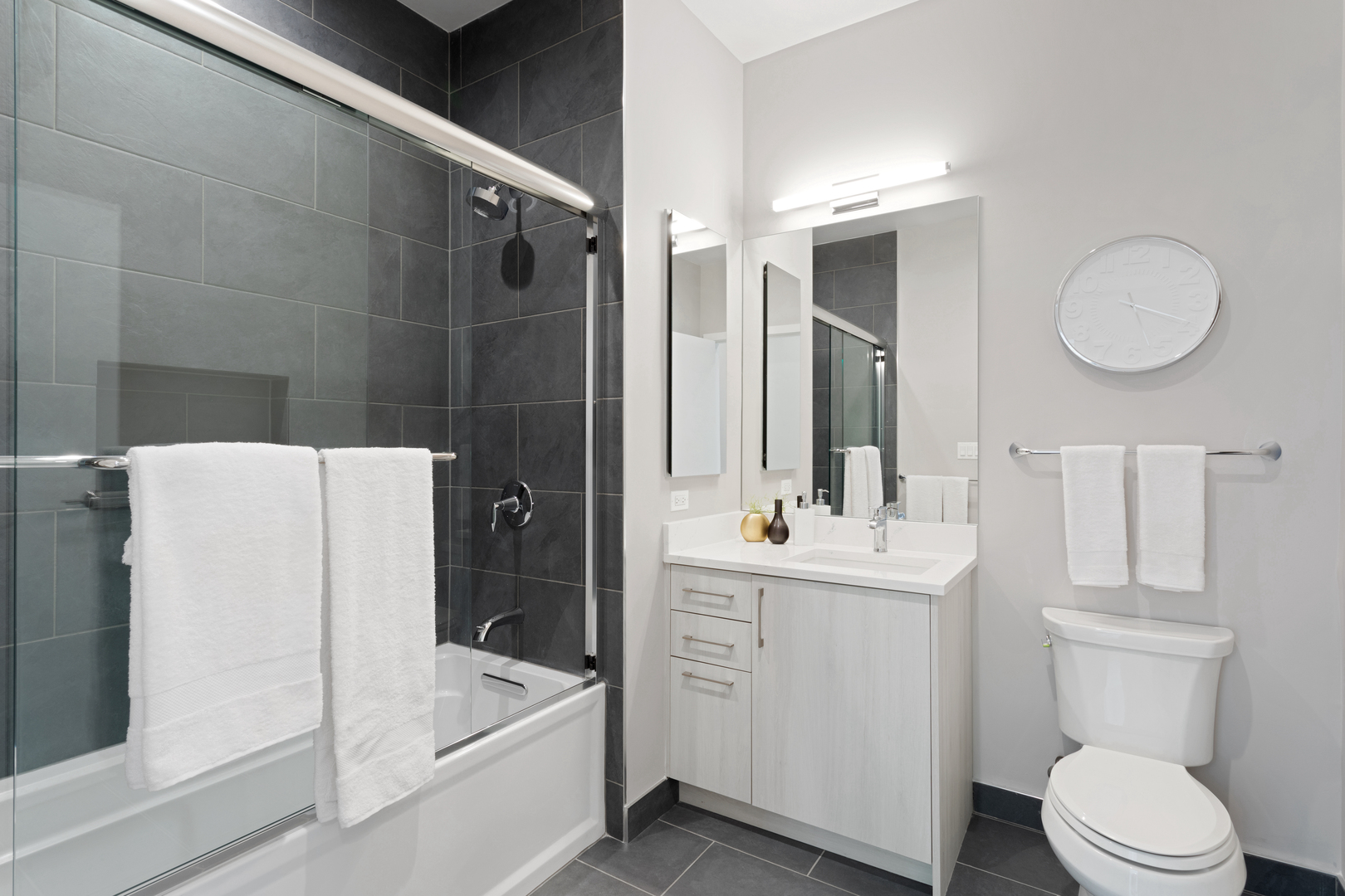 Undisclosed Address Chicago, IL 60618 - Photo 27 of 34 a bathroom with a bathtub shower sink mirror and toilet