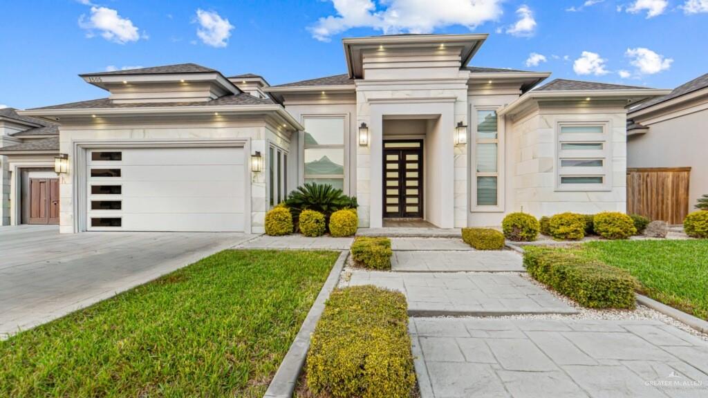 a front view of a house with a yard and garage