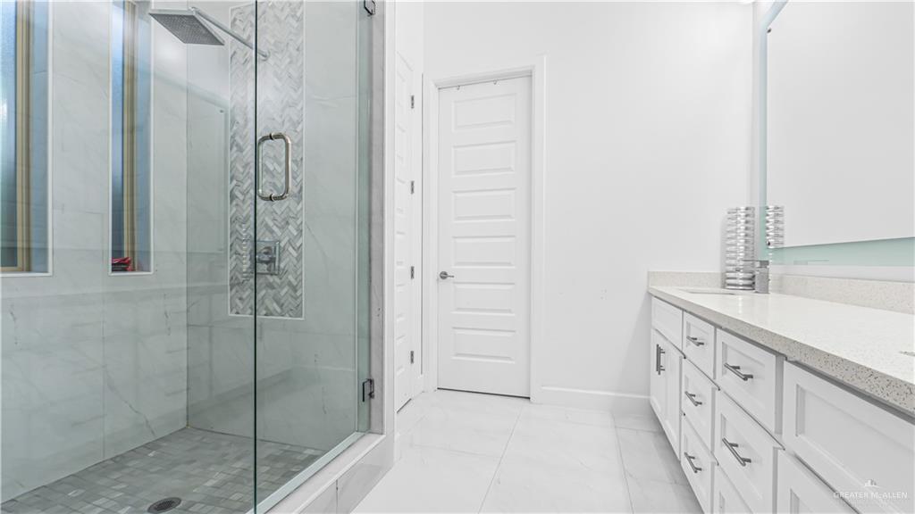 1505 Duke Street Mission, TX 78572 - Photo 19 of 39 a bathroom with a double vanity sink and shower