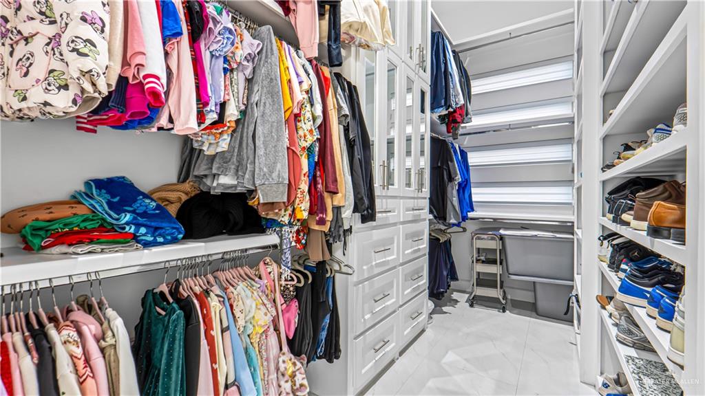 1505 Duke Street Mission, TX 78572 - Photo 20 of 39 a view of walk in closet with clothes and shoes
