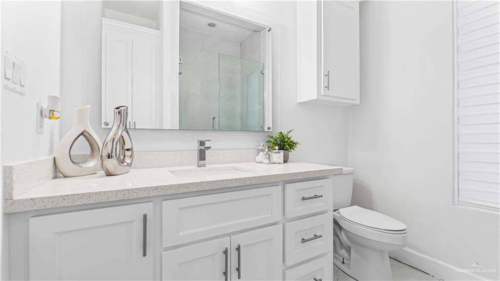 1505 Duke Street Mission, TX 78572 - Photo 24 of 39 a bathroom with a sink toilet and vanity