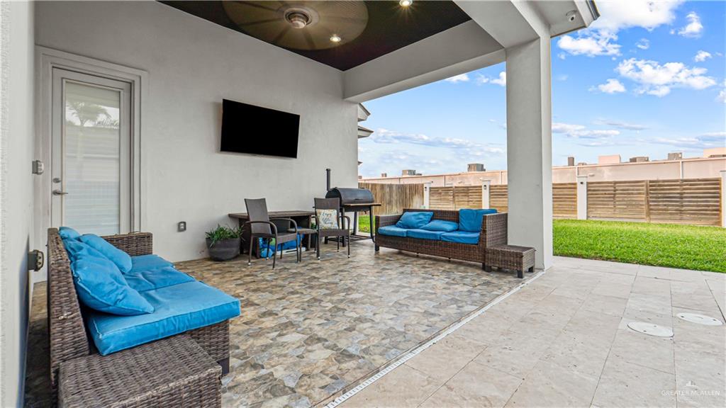 1505 Duke Street Mission, TX 78572 - Photo 29 of 39 a living room with furniture a flat screen tv and floor to ceiling window