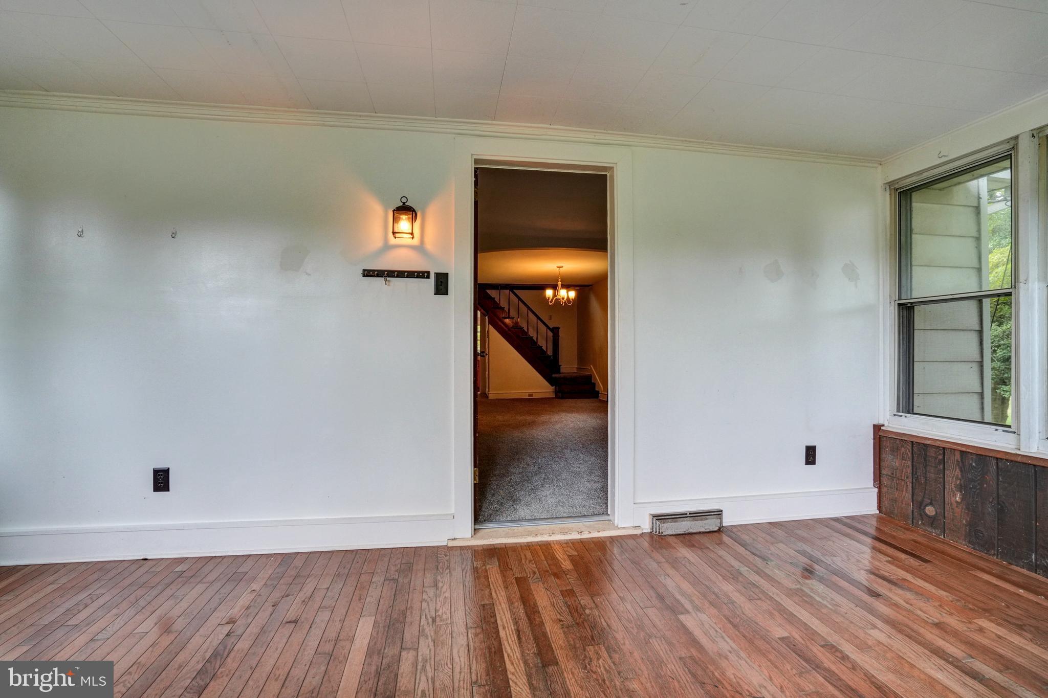 74 Baptist Church Road Spring City, PA 19475 - Photo 3 of 24 wooden floor in an empty room with a window