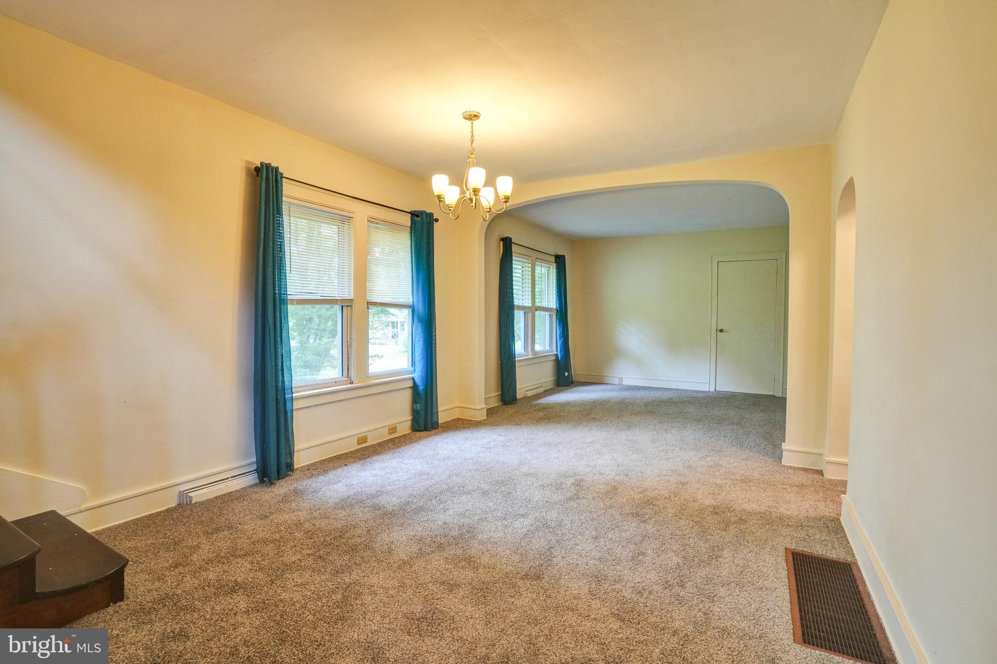 74 Baptist Church Road Spring City, PA 19475 - Photo 5 of 24 a view of an empty room with chandelier and a window