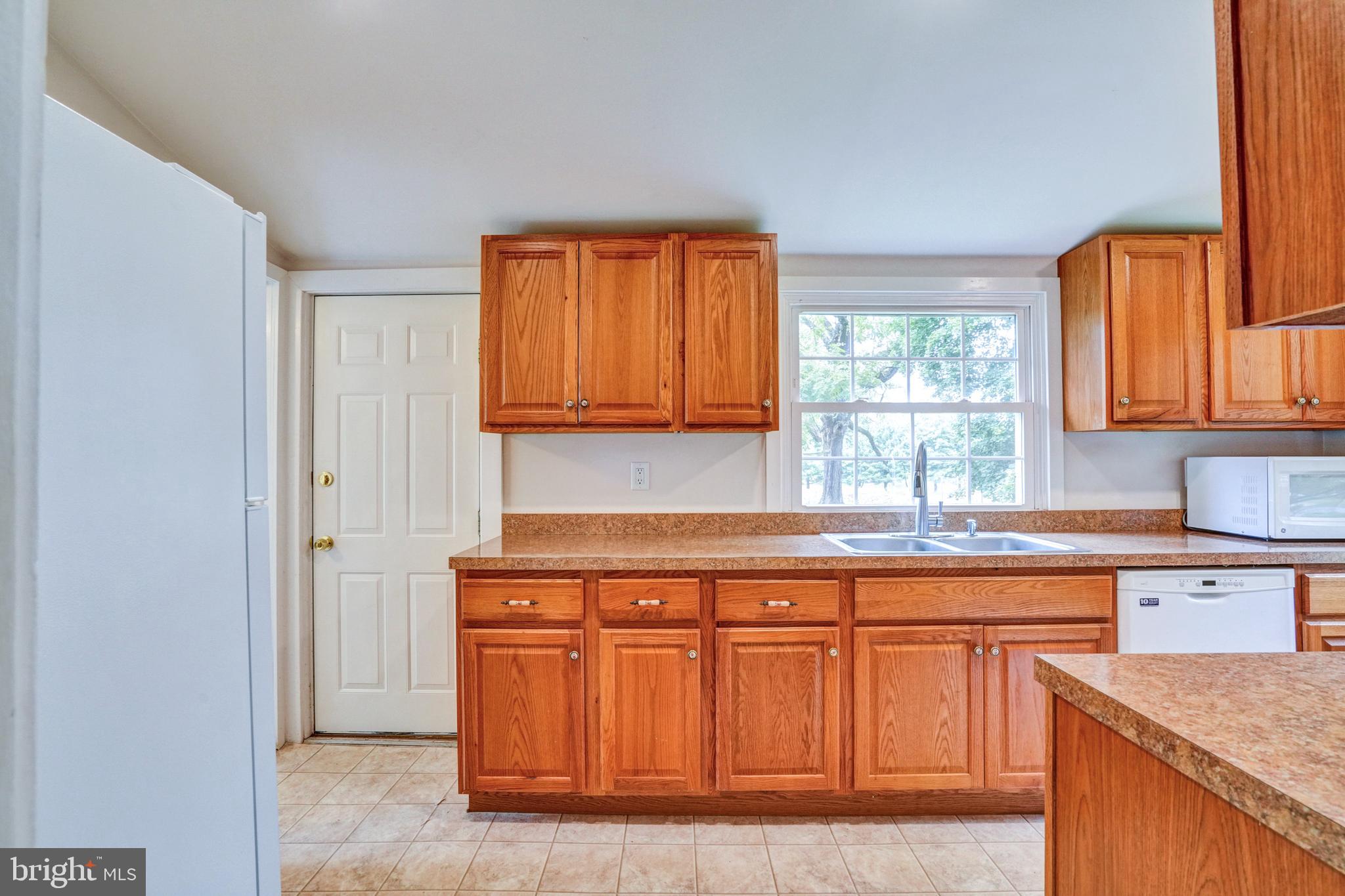 74 Baptist Church Road Spring City, PA 19475 - Photo 7 of 24 a kitchen with stainless steel appliances granite countertop a stove a sink and a microwave