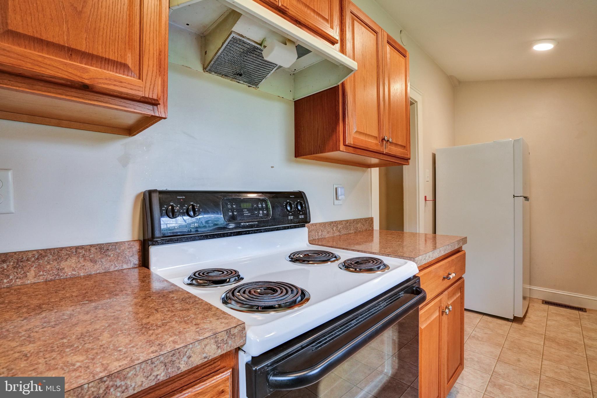 74 Baptist Church Road Spring City, PA 19475 - Photo 8 of 24 a kitchen with stainless steel appliances granite countertop a stove and a refrigerator