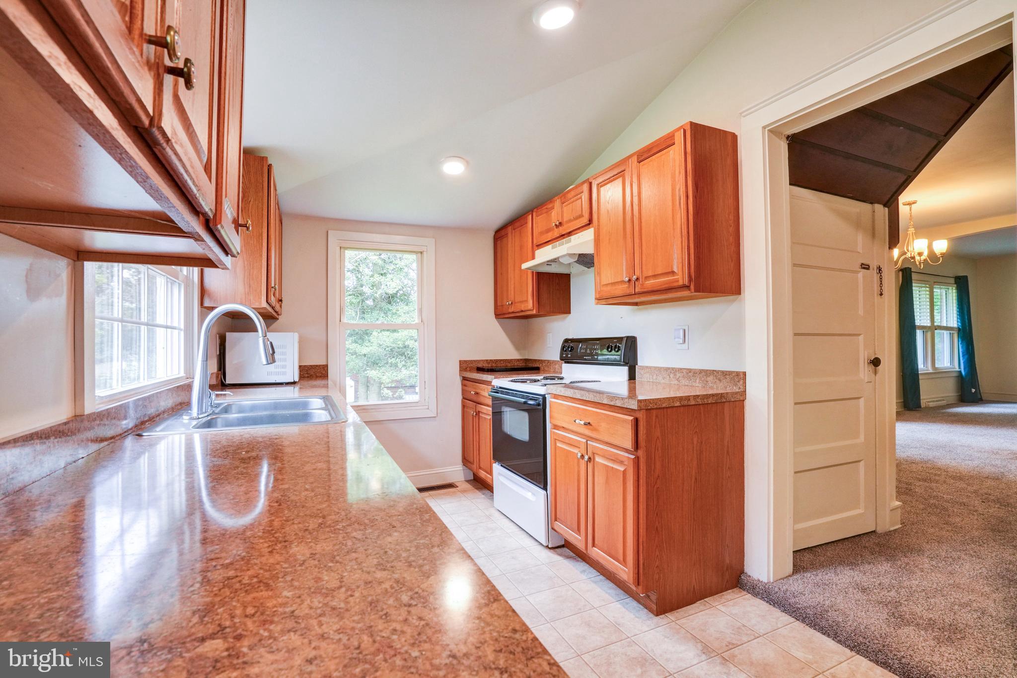 74 Baptist Church Road Spring City, PA 19475 - Photo 9 of 24 a kitchen with granite countertop a stove a sink and a refrigerator
