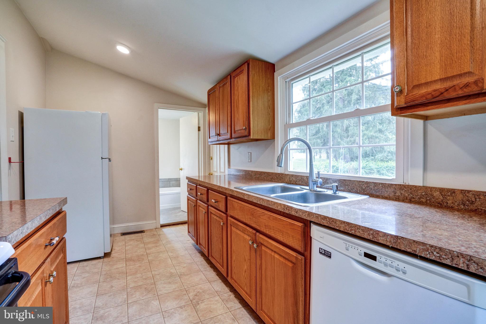 74 Baptist Church Road Spring City, PA 19475 - Photo 10 of 24 a kitchen with granite countertop a sink and a window