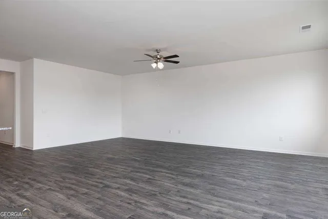a view of a kitchen with a dishwasher and wooden floor