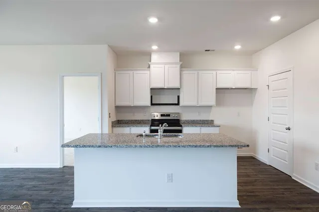 a kitchen with a sink stove and refrigerator