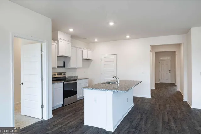 an empty room with closet and fan