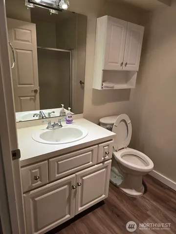 a bathroom with a sink toilet and mirror