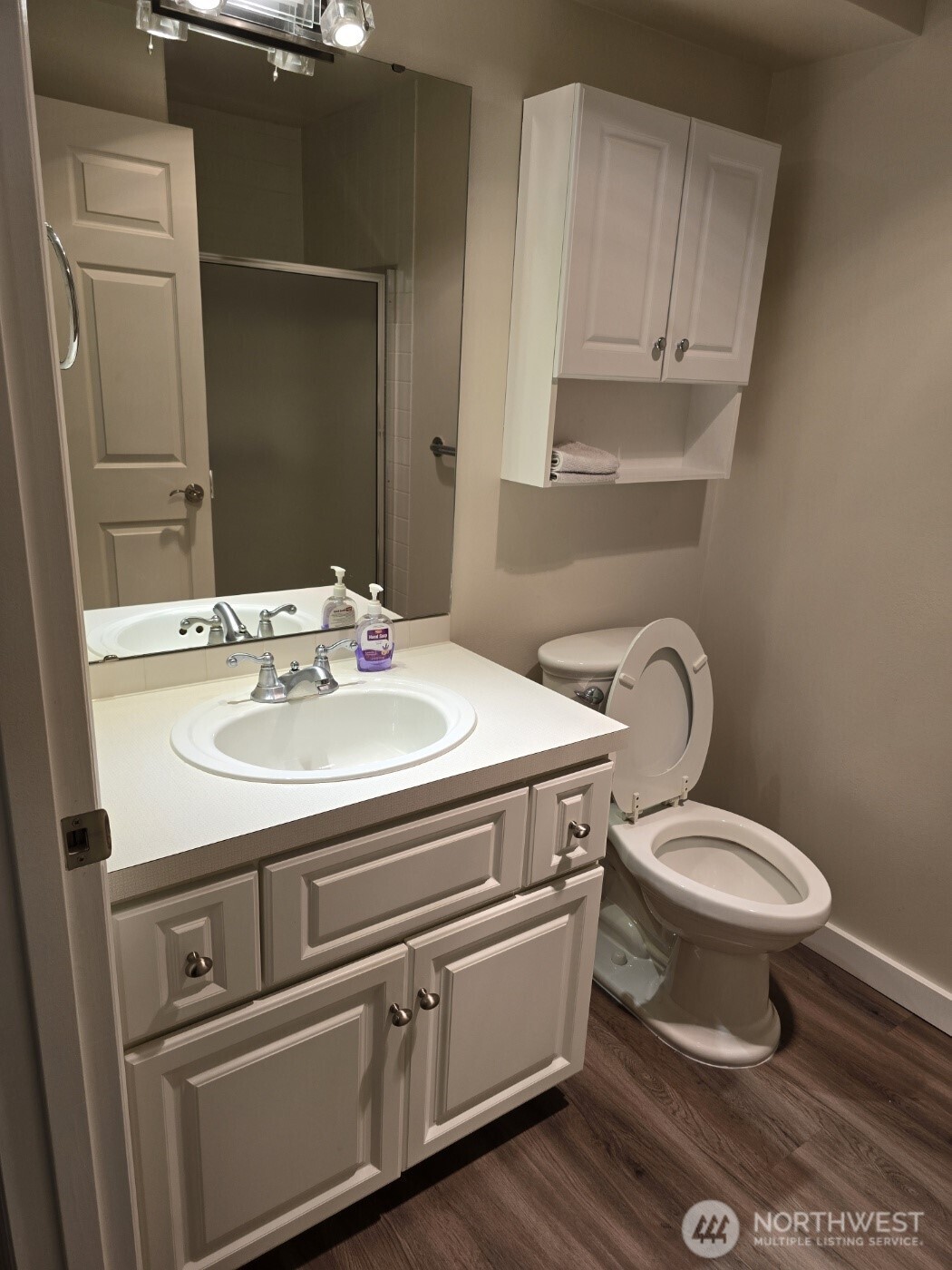 7207 210th Street Southwest, Unit 102 Edmonds, WA 98026 - Photo 13 of 14 a bathroom with a sink toilet and mirror