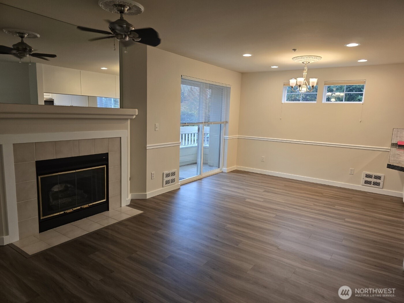 7207 210th Street Southwest, Unit 102 Edmonds, WA 98026 - Photo 2 of 14 a view of a livingroom with wooden floor a fireplace and window