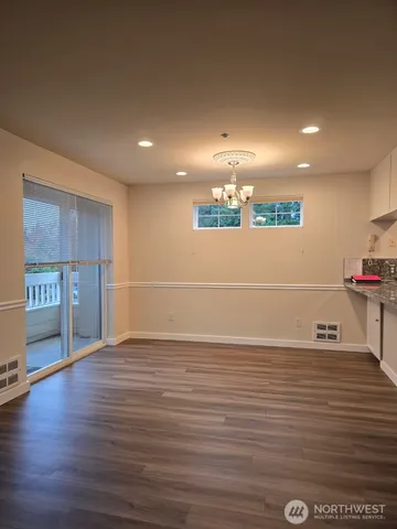 a view of a kitchen with a sink and a refrigerator