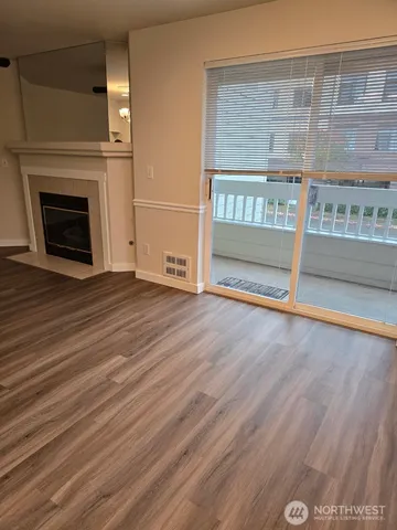 a view of a room with wooden floor
