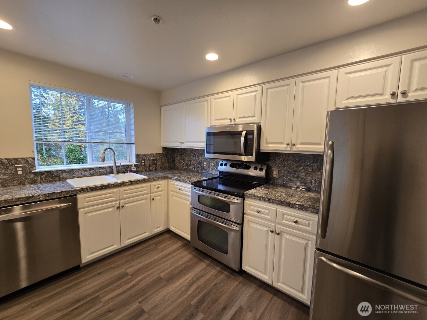 7207 210th Street Southwest, Unit 102 Edmonds, WA 98026 - Photo 5 of 14 a kitchen with a sink stove and microwave