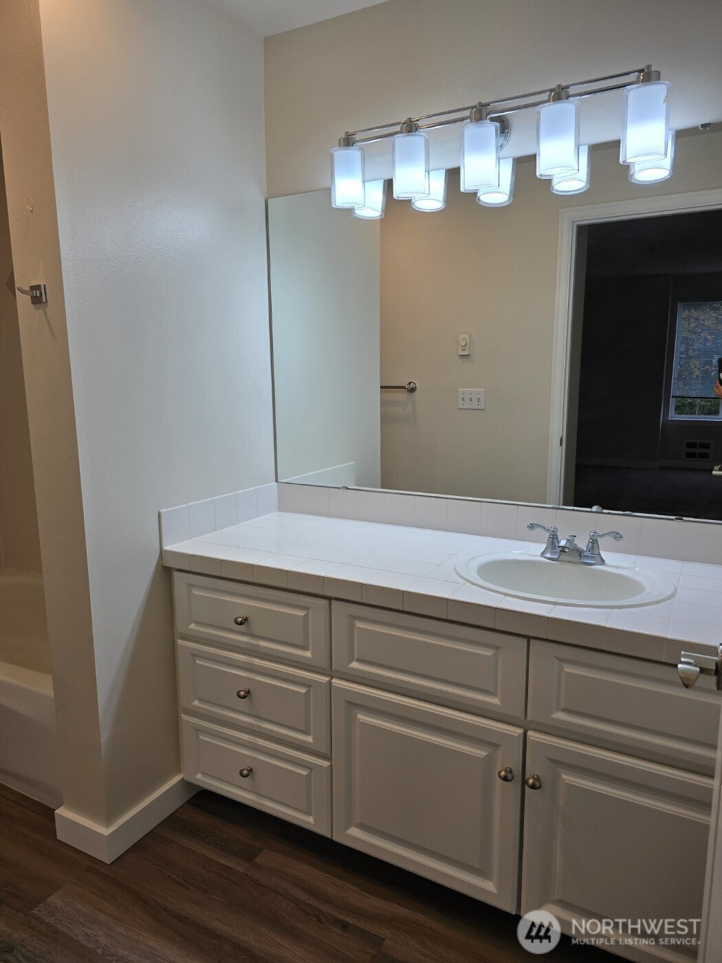 7207 210th Street Southwest, Unit 102 Edmonds, WA 98026 - Photo 10 of 14 a bathroom with a sink and a mirror