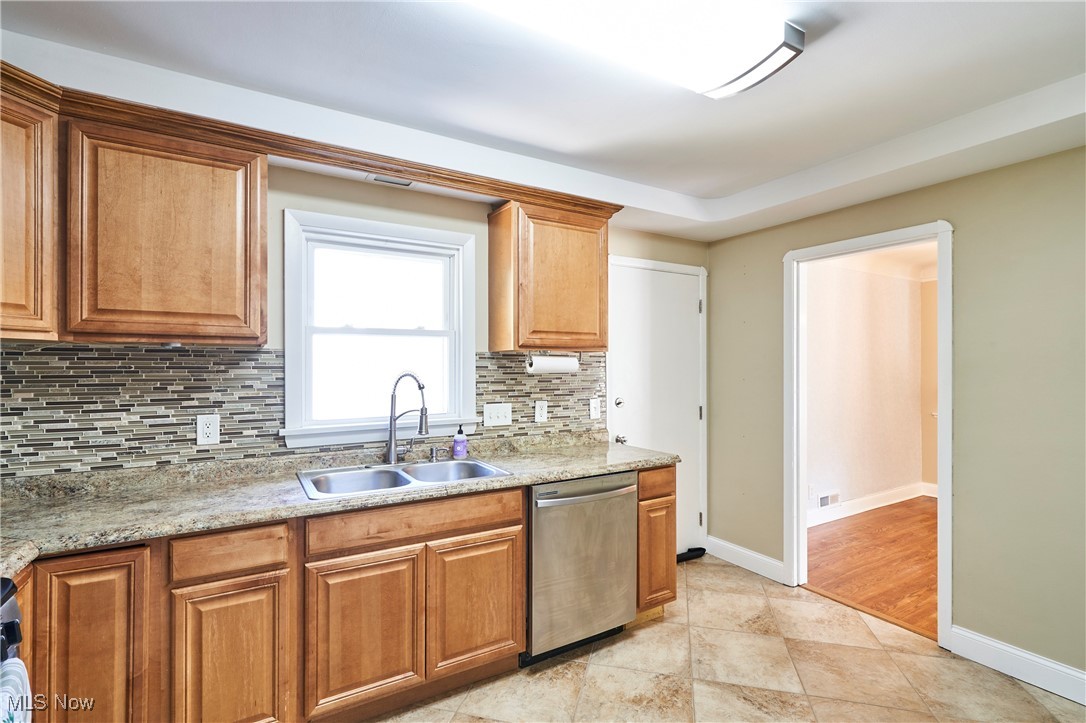 3100 West Ridgewood Drive Cleveland, OH 44134 - Photo 8 of 29 Kitchen with dishwasher, decorative backsplash, maple cabinets, and tile floors