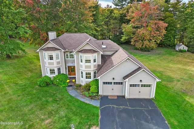 an aerial view of a house with garden space and street view