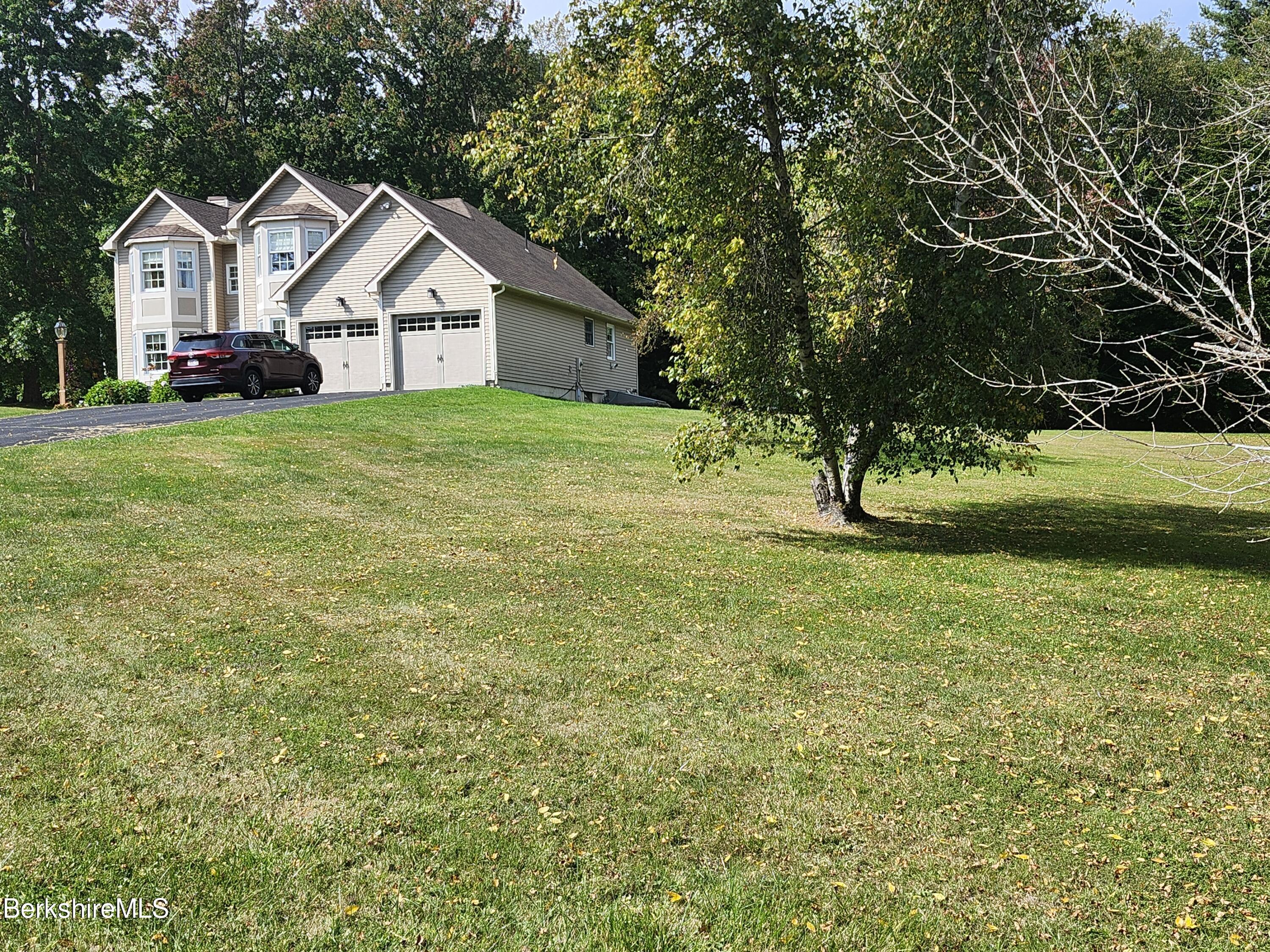 10 Lillybrook Road Pittsfield, MA 01201 - Photo 10 of 91 a front view of a house with a yard and trees