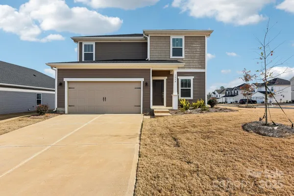 a front view of a house with a garage