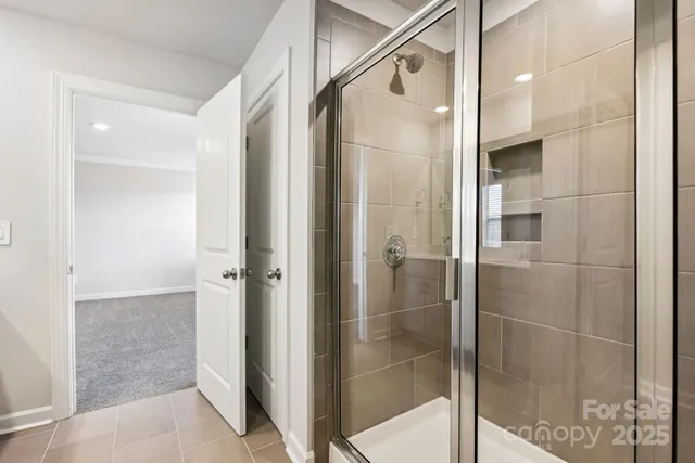 a bathroom with a glass shower door