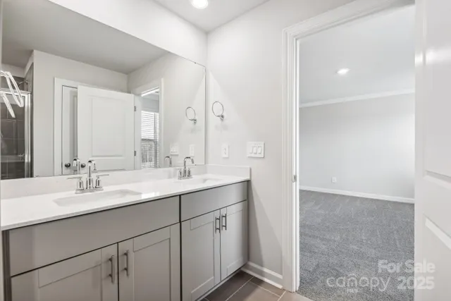 a bathroom with a double vanity sink and mirror