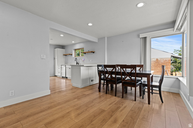 2101 West 3900th Street South Roy, UT 84067 - Photo 8 of 36 Open-concept living space featuring wood-finish flooring, recessed lighting, and a bright window alcove