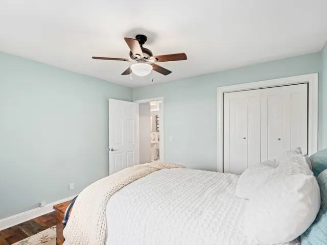 a bedroom with a large bed and a chandelier