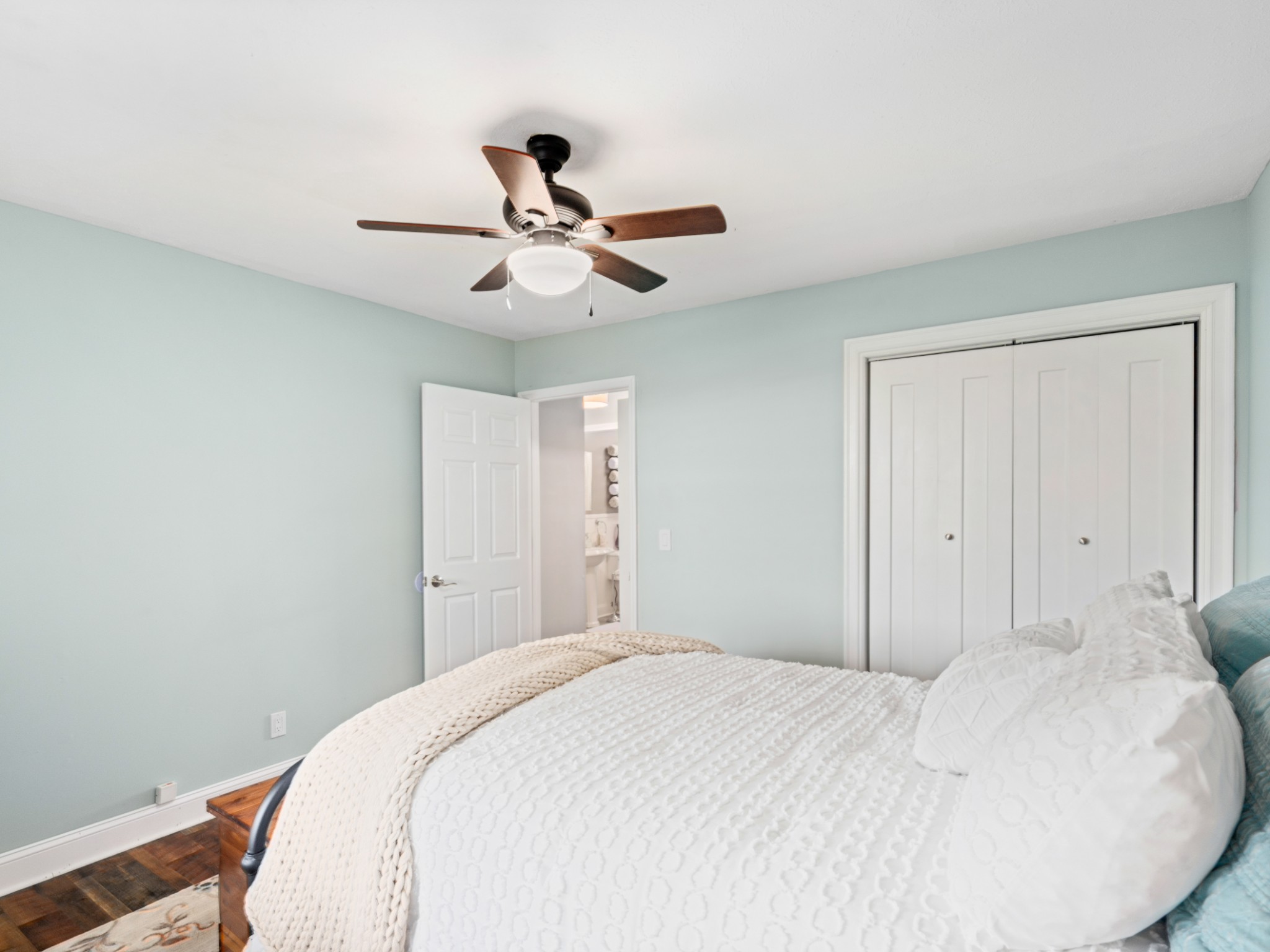 5439 Minnis Road Springfield, TN 37172 - Photo 15 of 43 a bedroom with a large bed and a chandelier