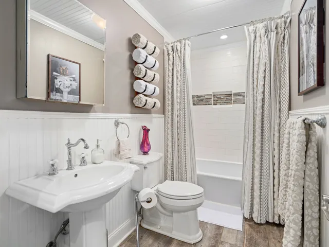 a bathroom with a sink toilet and shower