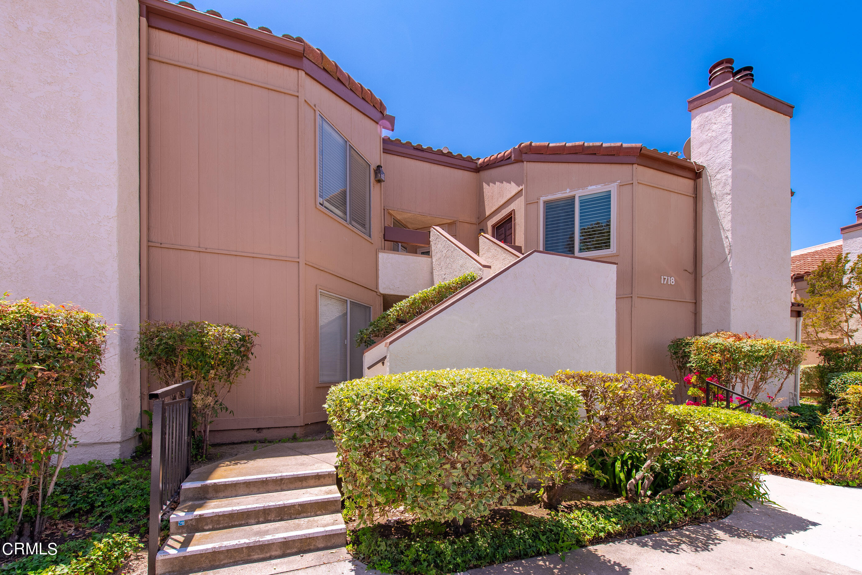 1718 Sinaloa Road, Unit 220 Simi Valley, CA 93065 - Photo 1 of 35 a front view of a house with a yard