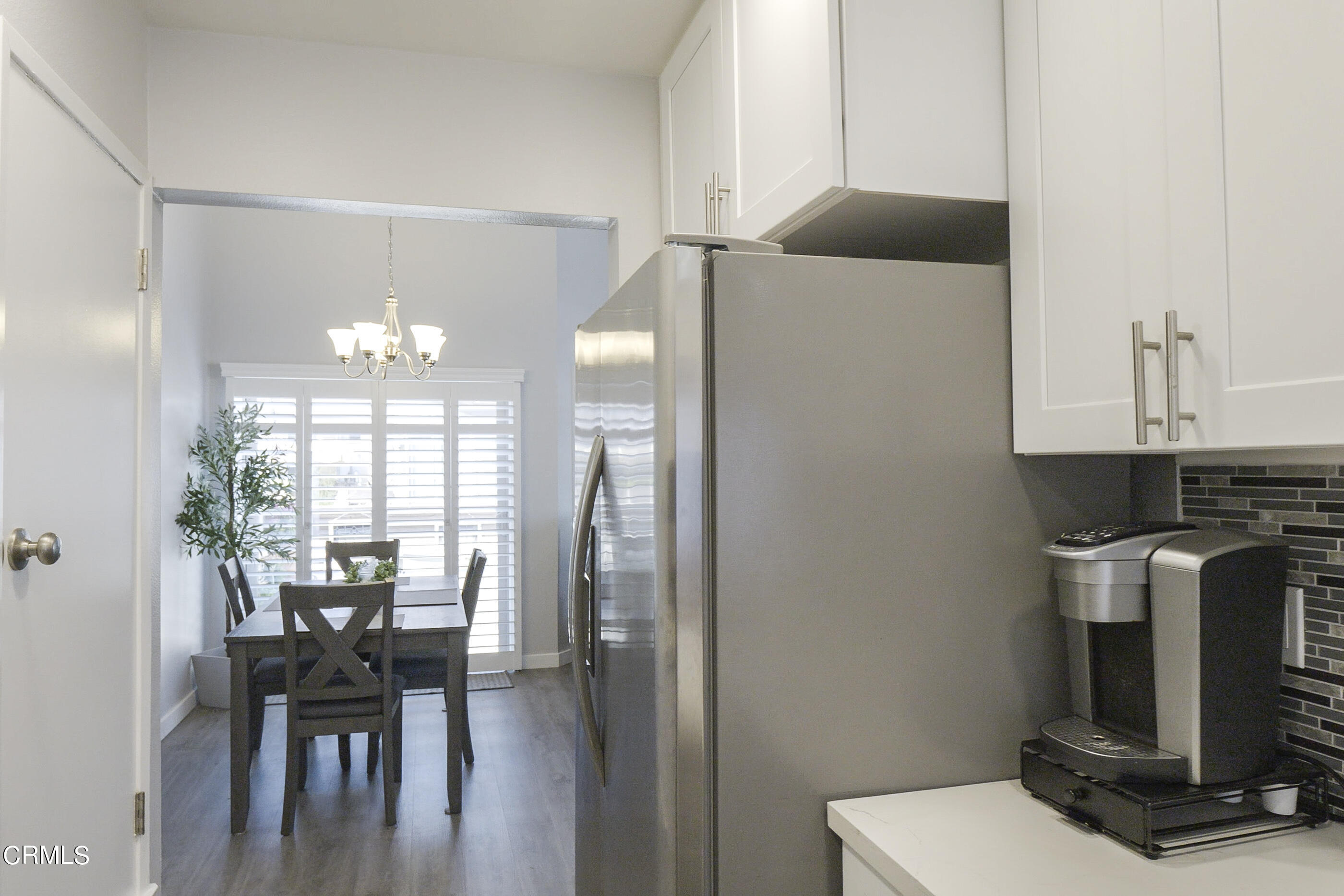 1718 Sinaloa Road, Unit 220 Simi Valley, CA 93065 - Photo 12 of 35 a view of a dining room with furniture and wooden floor