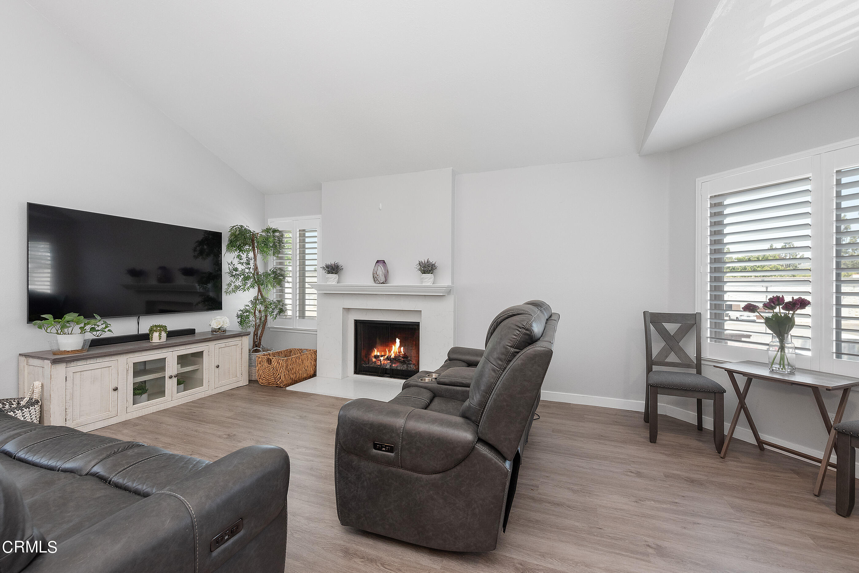 1718 Sinaloa Road, Unit 220 Simi Valley, CA 93065 - Photo 4 of 35 a living room with furniture a flat screen tv and a fireplace