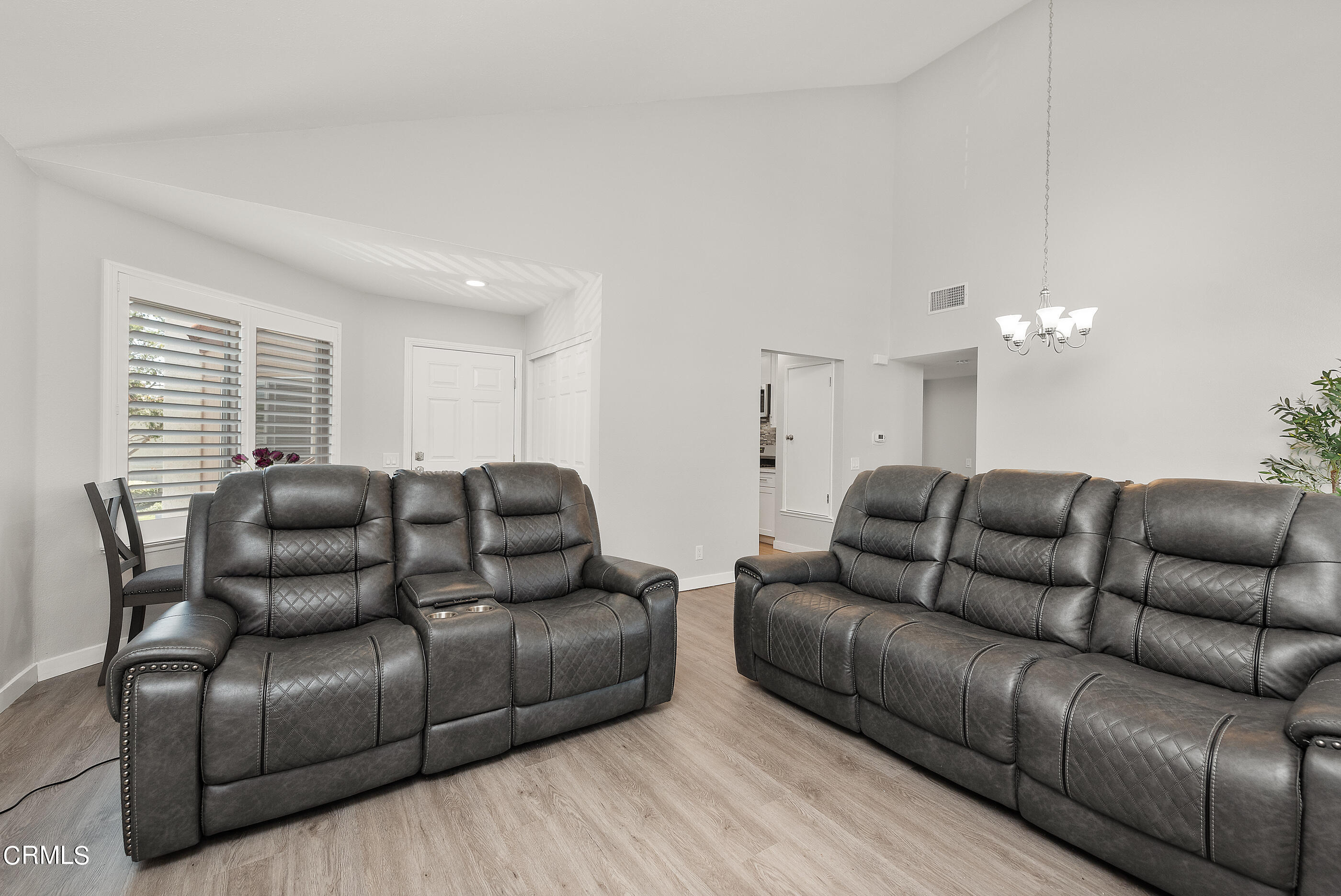 1718 Sinaloa Road, Unit 220 Simi Valley, CA 93065 - Photo 5 of 35 a living room with furniture a couch and a chandelier