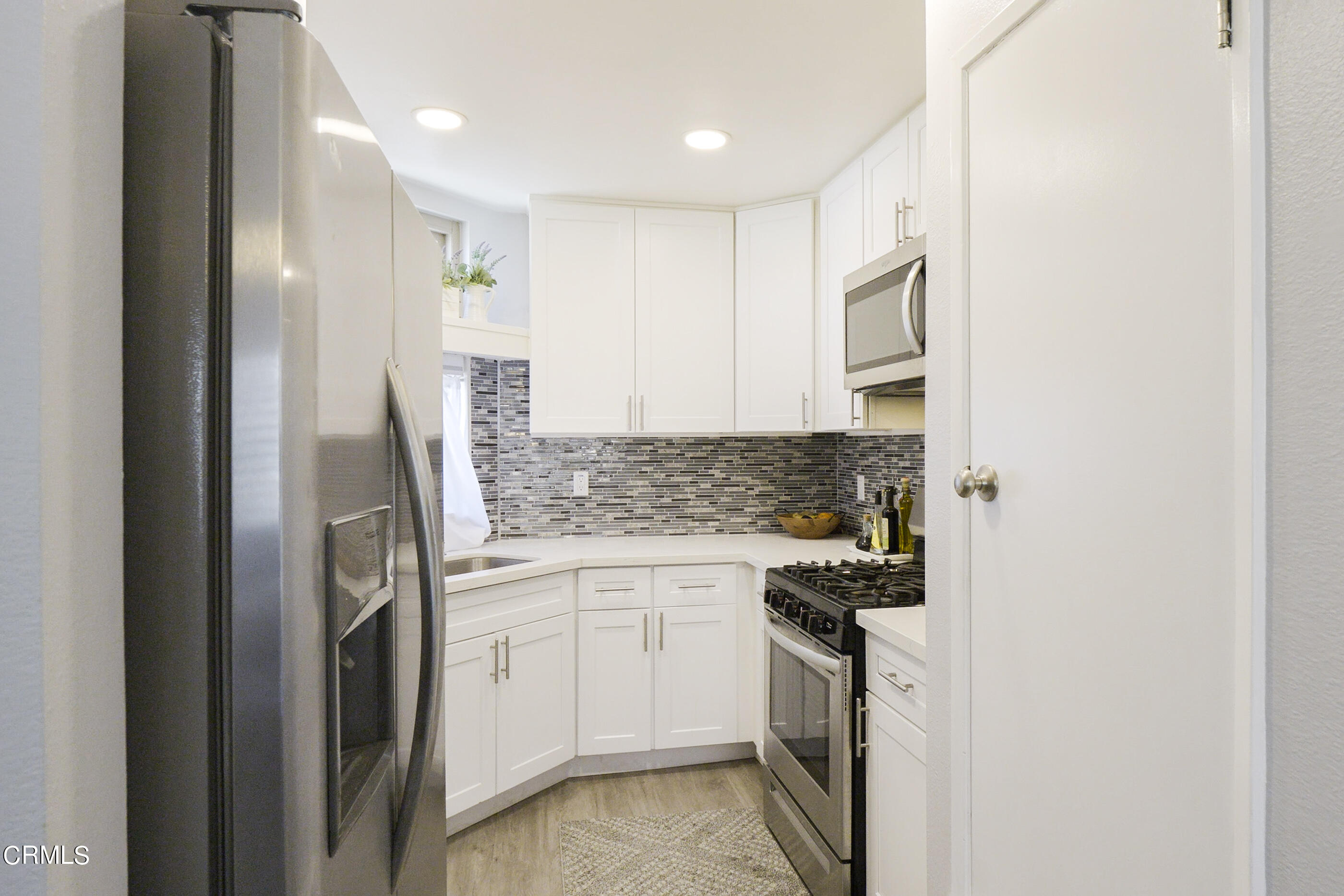 1718 Sinaloa Road, Unit 220 Simi Valley, CA 93065 - Photo 10 of 35 a kitchen with a sink and refrigerator