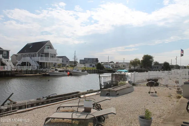 a view of a lake with a car parked in front of house