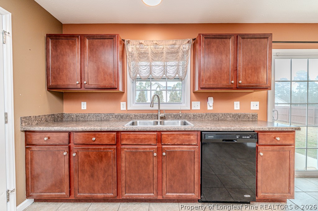445 Hayden Lane Cameron, NC 28326 - Photo 13 of 49 a kitchen with granite countertop wooden cabinets a sink and a window
