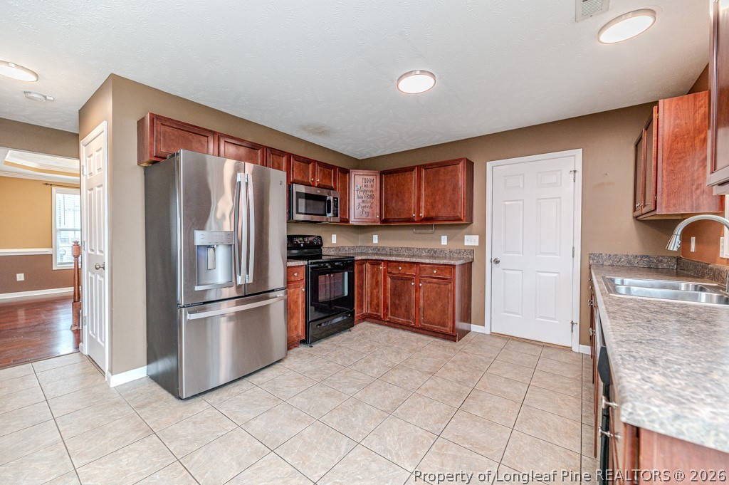 445 Hayden Lane Cameron, NC 28326 - Photo 14 of 49 a kitchen with granite countertop a refrigerator stove top oven and sink