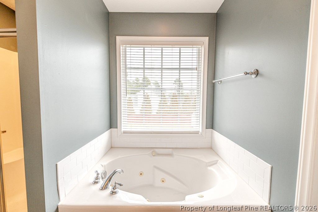 445 Hayden Lane Cameron, NC 28326 - Photo 18 of 49 a bathroom with a bathtub and a window
