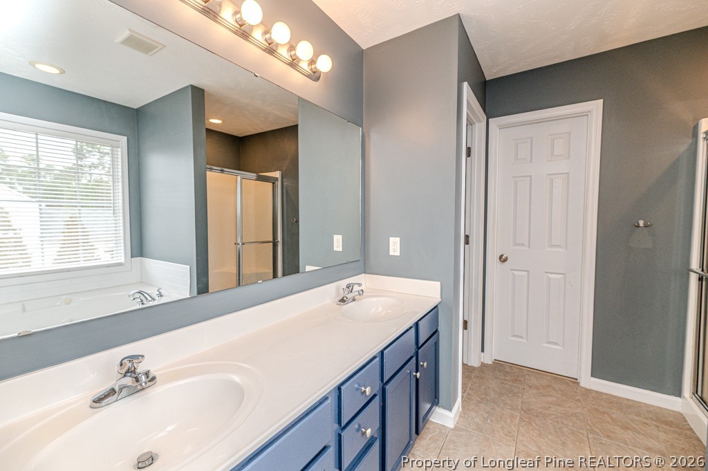 445 Hayden Lane Cameron, NC 28326 - Photo 21 of 49 a spacious bathroom with a double vanity sink mirror and next to a large window