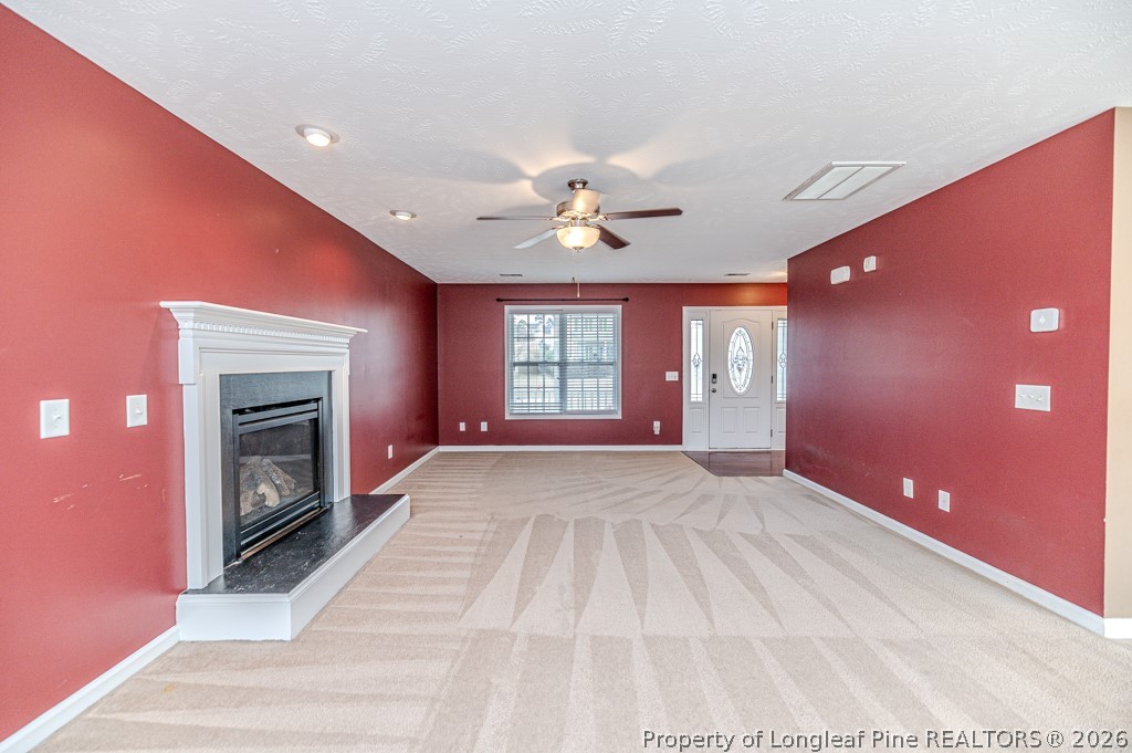 445 Hayden Lane Cameron, NC 28326 - Photo 6 of 49 a view of an empty room with a fireplace and a window
