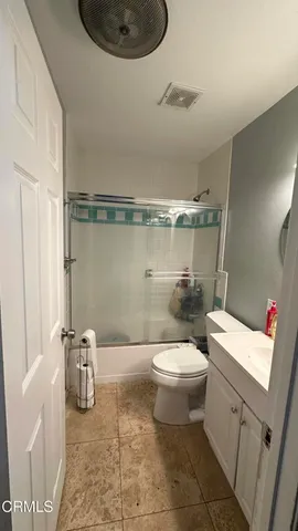 a bathroom with a toilet a sink and shower